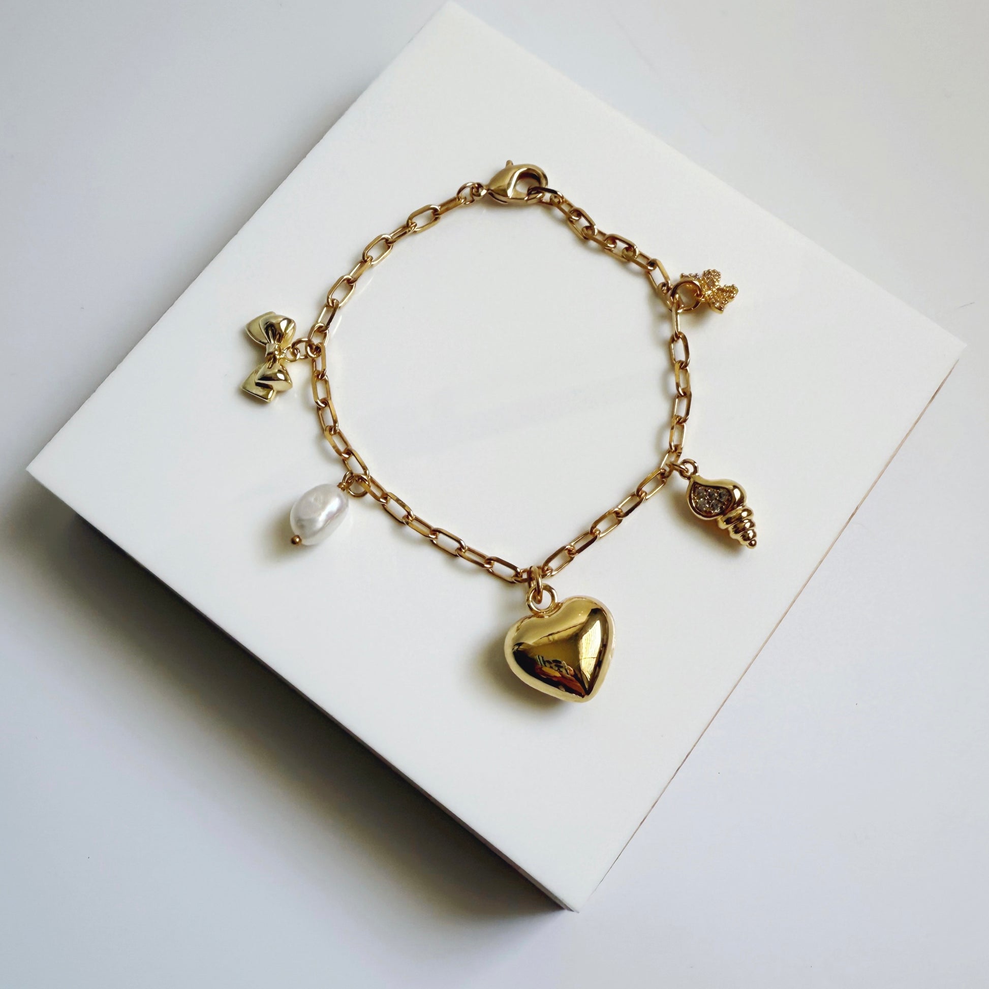 Puffy heart and shell charm bracelet